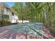 A fenced tennis court is nestled within a lush, green wooded area of the property at 4340 Candacraig, Johns Creek, GA 30022