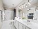 Bright bathroom features a double vanity, tub/shower combo, and a large mirror reflecting the Primary bedroom at 2324 Towneheights Se Ter # 11, Atlanta, GA 30339