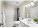 Bathroom with tub and shower, toilet, large mirror, and sink vanity with storage and modern fixtures at 2324 Towneheights Se Ter # 11, Atlanta, GA 30339