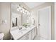 Bathroom boasts a double vanity with modern fixtures, a large mirror, and contemporary lighting at 2324 Towneheights Se Ter # 11, Atlanta, GA 30339