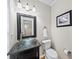 Elegant half-bathroom with glass bowl sink and decorative mirror at 2324 Towneheights Se Ter # 11, Atlanta, GA 30339