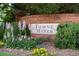 Landscaped community entrance sign featuring colorful flower beds and mature greenery at 2324 Towneheights Se Ter # 11, Atlanta, GA 30339