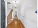 Bright foyer with hardwood floors, elegant lighting, and staircase leading to the upper level at 2324 Towneheights Se Ter # 11, Atlanta, GA 30339