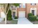 Brick townhouse front door with attached garage and manicured shrubbery at 2324 Towneheights Se Ter # 11, Atlanta, GA 30339