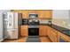 Charming kitchen features stainless steel appliances and beautiful wood cabinets at 2324 Towneheights Se Ter # 11, Atlanta, GA 30339