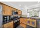 Bright kitchen features stainless steel appliances, wood cabinets, and granite countertops at 2324 Towneheights Se Ter # 11, Atlanta, GA 30339