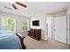 Comfortable bedroom with a ceiling fan, large windows, a dresser, and easy access to the hallway at 2324 Towneheights Se Ter # 11, Atlanta, GA 30339
