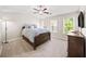 Spacious bedroom featuring a ceiling fan, ample natural light, and a modern dresser for storage at 2324 Towneheights Se Ter # 11, Atlanta, GA 30339