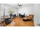 Bright home office featuring a ceiling fan, hardwood floors, multiple desks and chairs, and a comfortable leather chair at 2324 Towneheights Se Ter # 11, Atlanta, GA 30339
