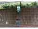 Dog waste bag station by a stone wall and wrought iron fence at 2324 Towneheights Se Ter # 11, Atlanta, GA 30339