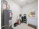 Functional utility room with water heater, storage shelves, and access to the outside at 2324 Towneheights Se Ter # 11, Atlanta, GA 30339