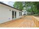New wooden back deck features stylish white siding, French doors, and overlooks the backyard at 2450 Elkhorn Dr, Decatur, GA 30034