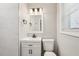 Bathroom featuring modern vanity, lighting, and a tiled shower with glass partition at 2450 Elkhorn Dr, Decatur, GA 30034