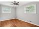 Bedroom with hardwood floors, neutral paint, and natural light from two windows at 2450 Elkhorn Dr, Decatur, GA 30034
