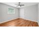 This bedroom features hardwood floors, neutral paint, a ceiling fan, and one window at 2450 Elkhorn Dr, Decatur, GA 30034