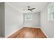 This bedroom features hardwood floors, neutral paint, a ceiling fan, and a window at 2450 Elkhorn Dr, Decatur, GA 30034