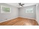 This bedroom features hardwood floors, a ceiling fan, neutral paint, and two windows at 2450 Elkhorn Dr, Decatur, GA 30034