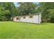 Side exterior view of painted brick home on green lawn showing painted window shutters at 2450 Elkhorn Dr, Decatur, GA 30034