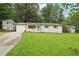 Charming white brick home with a well-manicured front lawn and driveway at 2450 Elkhorn Dr, Decatur, GA 30034