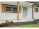 Inviting front porch with a decorative light blue door, wooden shutters, and fresh landscaping at 2450 Elkhorn Dr, Decatur, GA 30034