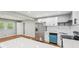 Modern kitchen with stainless steel refrigerator, white cabinets, and quartz countertops at 2450 Elkhorn Dr, Decatur, GA 30034
