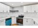 Updated kitchen features white cabinets, stainless steel appliances, and subway tile backsplash at 2450 Elkhorn Dr, Decatur, GA 30034