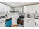 Updated kitchen with quartz counters, stainless appliances, white subway tile backsplash, and modern finishes at 2450 Elkhorn Dr, Decatur, GA 30034