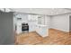 Modern kitchen with white cabinets, island, stainless appliances, and hardwood floors at 2450 Elkhorn Dr, Decatur, GA 30034