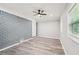 Spacious living room with a gray brick wall and wood floors at 2450 Elkhorn Dr, Decatur, GA 30034