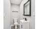 Modern powder room with vanity sink, sleek black fixtures, and mirror at 2450 Elkhorn Dr, Decatur, GA 30034