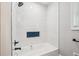 This renovated bathroom has a new shower, tub and blue accent shelf at 2450 Elkhorn Dr, Decatur, GA 30034