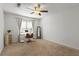 Spacious bedroom featuring a desk, ceiling fan, carpeted floor, and a large window at 970 Sidney Marcus Ne Blvd # 2408, Atlanta, GA 30324