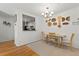 Bright dining room area with modern chandelier and decorative wall art next to a kitchen at 970 Sidney Marcus Ne Blvd # 2408, Atlanta, GA 30324