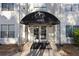 Welcoming entrance with the Lenox Villas logo and unit number above the doors, and well-maintained landscaping at 970 Sidney Marcus Ne Blvd # 2408, Atlanta, GA 30324
