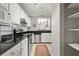 Updated kitchen with modern appliances, white cabinets, and a breakfast bar overlooking the dining room at 970 Sidney Marcus Ne Blvd # 2408, Atlanta, GA 30324
