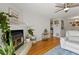 Bright living room showcasing a fireplace, hardwood floors, a ceiling fan, and a mini-bar at 970 Sidney Marcus Ne Blvd # 2408, Atlanta, GA 30324