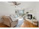 Inviting living room featuring a ceiling fan, fireplace, a sliding door, and stylish decor at 970 Sidney Marcus Ne Blvd # 2408, Atlanta, GA 30324