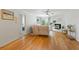 Open living room with hardwood floors, fireplace, ceiling fan, and a glimpse into the bedroom at 970 Sidney Marcus Ne Blvd # 2408, Atlanta, GA 30324