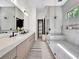 Modern bathroom featuring dual sinks, a glass shower, and stylish design and lighting at 191 Darwish Dr, Mcdonough, GA 30252