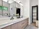 Bathroom with a double sink vanity, large mirror, and a view into the glass shower at 191 Darwish Dr, Mcdonough, GA 30252