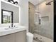 Modern bathroom features a walk-in shower, sleek vanity, and minimalist design at 191 Darwish Dr, Mcdonough, GA 30252