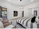 Stylish bedroom with king bed, deck access, a mounted TV and stylish modern furniture at 191 Darwish Dr, Mcdonough, GA 30252
