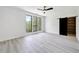 Bright bedroom features hardwood floors, barn door closet, and large windows with views of lush greenery at 191 Darwish Dr, Mcdonough, GA 30252