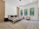 Modern bedroom with stylish furniture, a king bed, wood floors and outdoor trees view at 191 Darwish Dr, Mcdonough, GA 30252