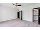 Spacious bedroom with ample natural light, a ceiling fan, and modern flooring at 191 Darwish Dr, Mcdonough, GA 30252