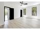 A bright bedroom features modern flooring and windows with a wooded view at 191 Darwish Dr, Mcdonough, GA 30252