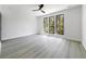 Bright bedroom featuring large windows with a view, light floors, and white walls at 191 Darwish Dr, Mcdonough, GA 30252