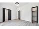 Open bedroom with light wood floors and black doors at 191 Darwish Dr, Mcdonough, GA 30252