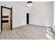 Bright, empty bedroom with wood floors and black doors at 191 Darwish Dr, Mcdonough, GA 30252