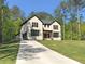 Two-story home featuring brick accents, well-manicured lawn and long driveway at 191 Darwish Dr, Mcdonough, GA 30252